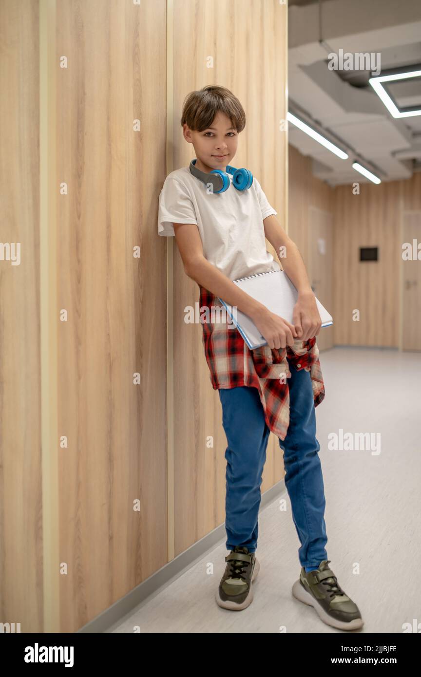 A boy with headphones in the school corridor Stock Photo - Alamy