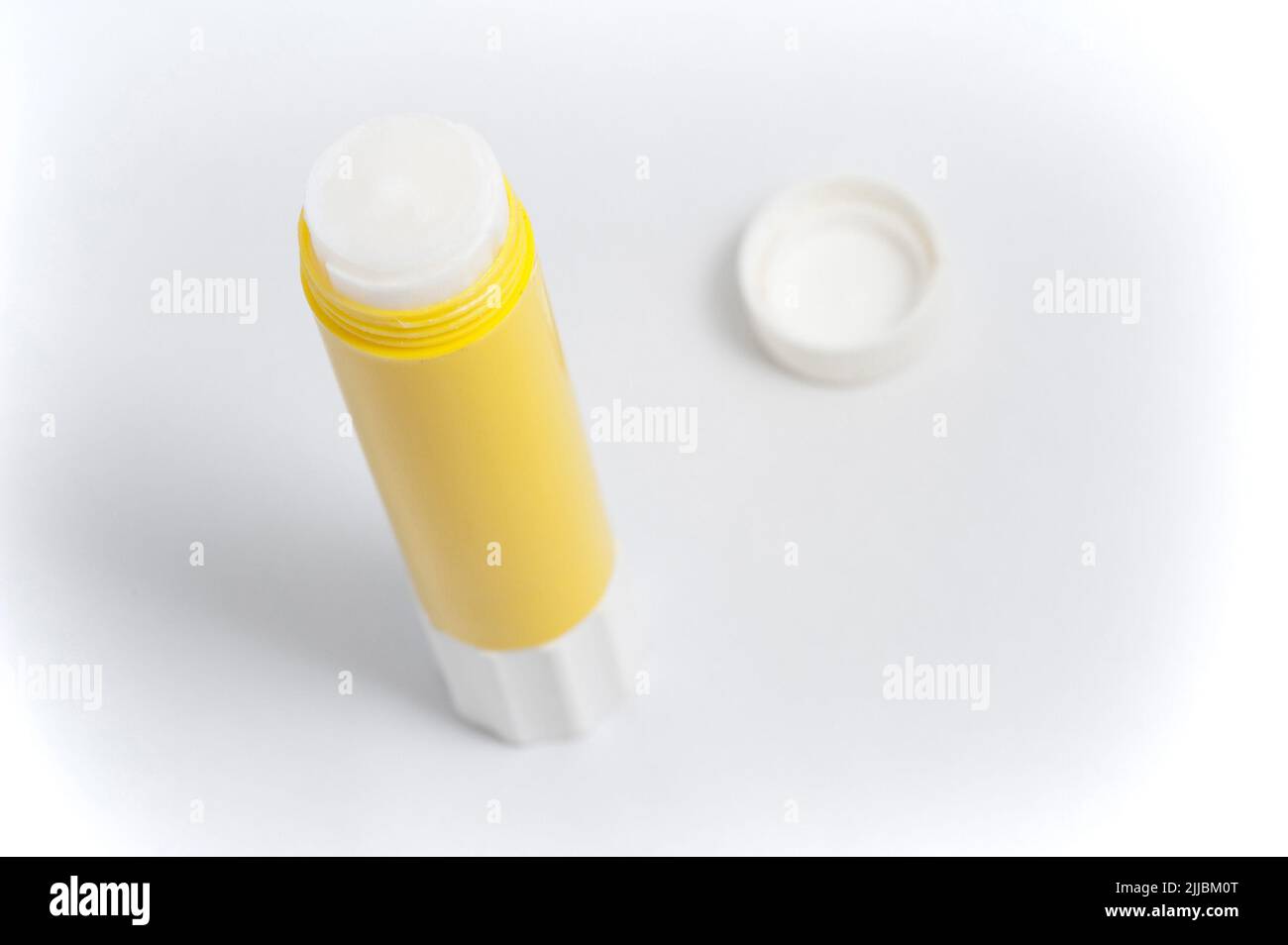 Opened yellow glue stick on white background Stock Photo Alamy