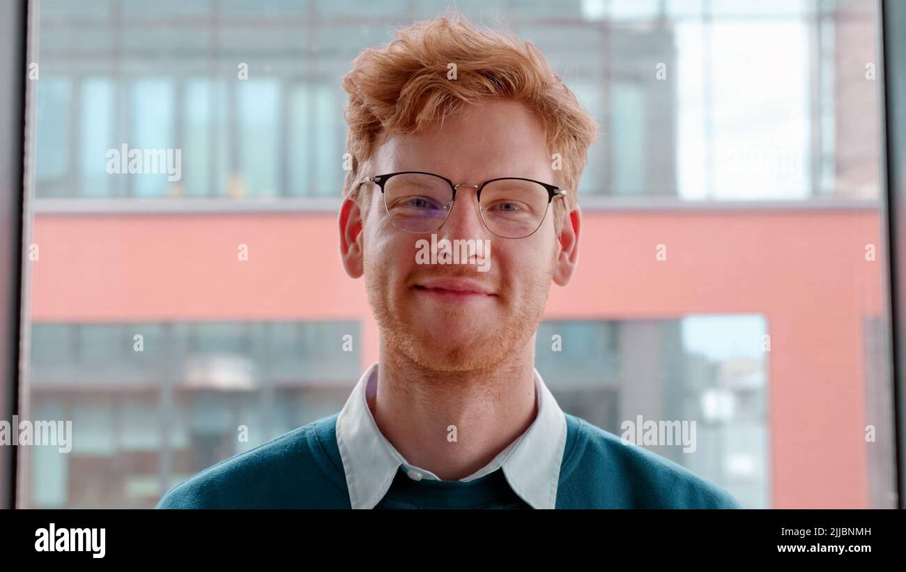 Young ginger irish man in glasses crossing hands on chest portrait Stock Photo