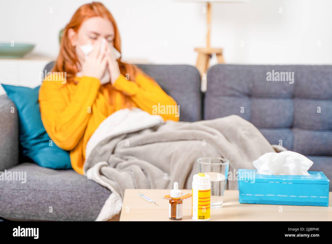 Sick woman with fever symptoms at home Stock Photo