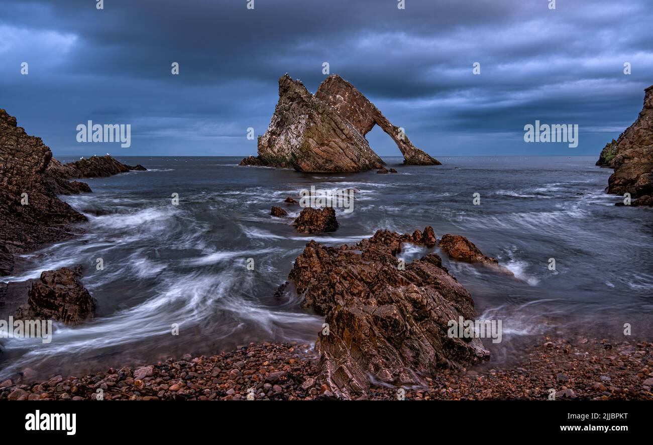 Bow Fiddle Rock is a natural sea arch near Portknockie on the Moray coast of Scotland Stock Photo