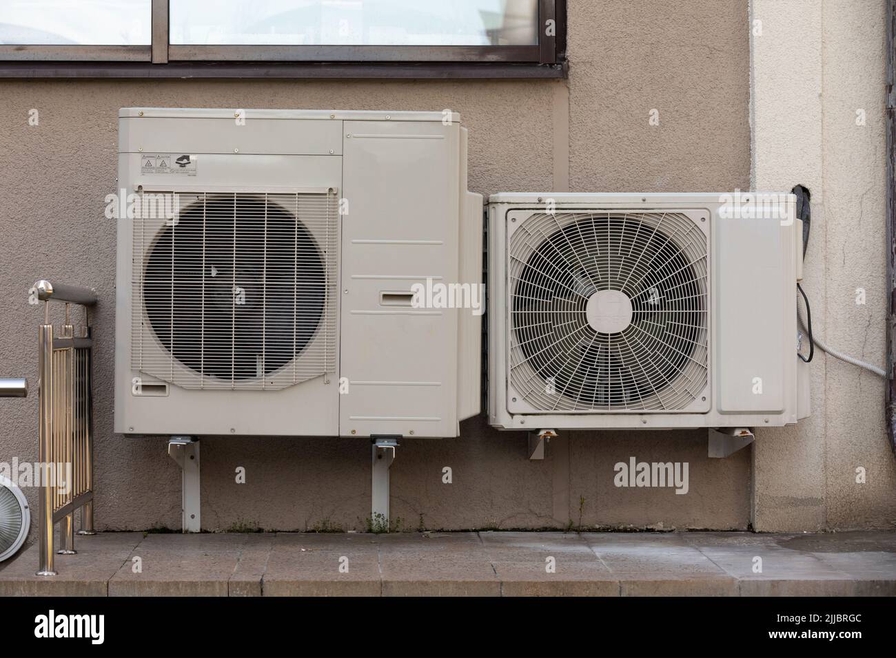 two units of outdoor air conditioners for heat dissipation are hung on