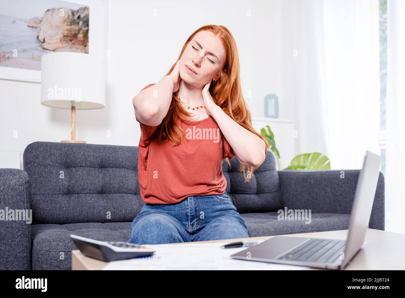 Woman suffering cervical pain with bad working posture Stock Photo