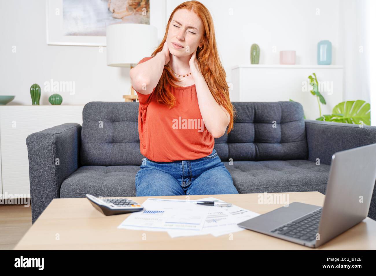 Woman suffering cervical pain with bad working posture Stock Photo