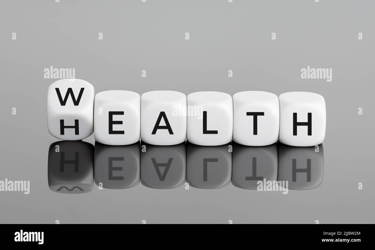 Wealth and Health concept. Flipping cube block with text Stock Photo