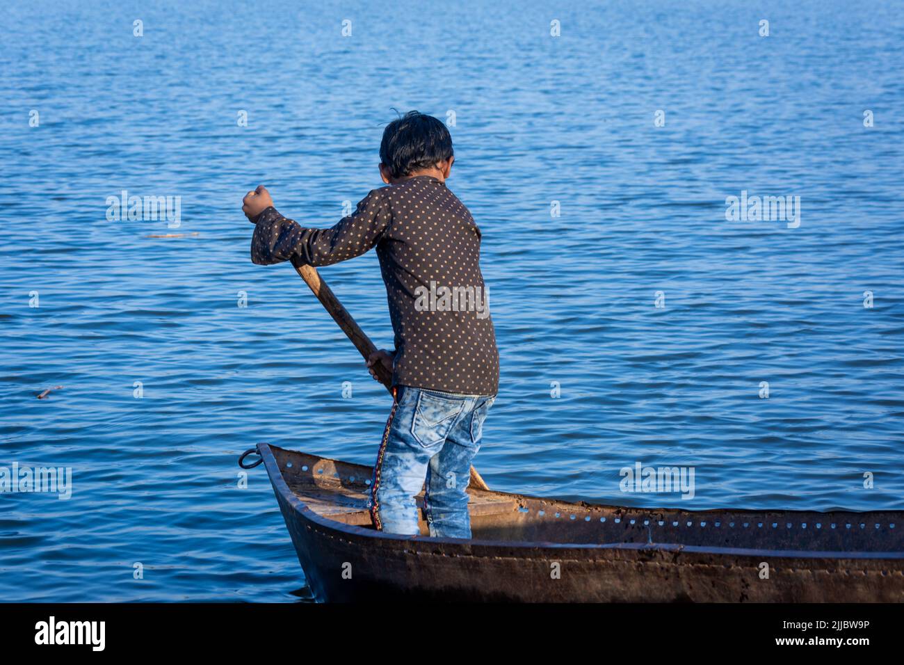 TIKAMGARH, MADHYA PRADESH, INDIA - JUNE 05, 2022: Indian boy boating in the river. Stock Photo