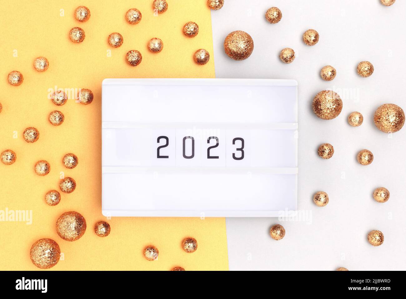 New 2023 Year. Lightbox and golden round glittering confetti. Stock Photo