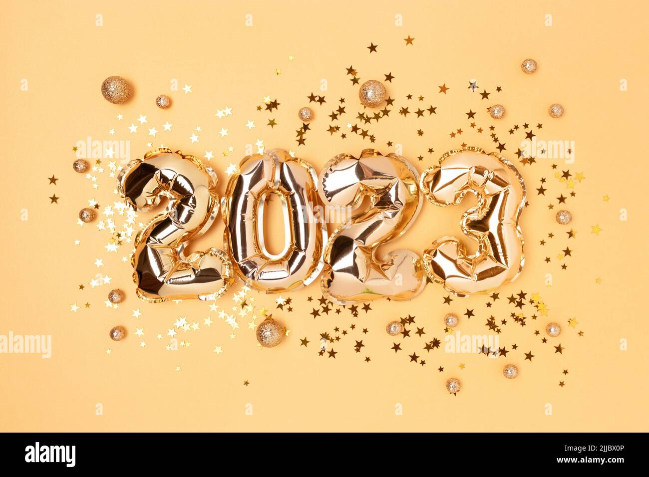 2023 gold balloons, stars and round confetti. Monochrome festive composition. Stock Photo