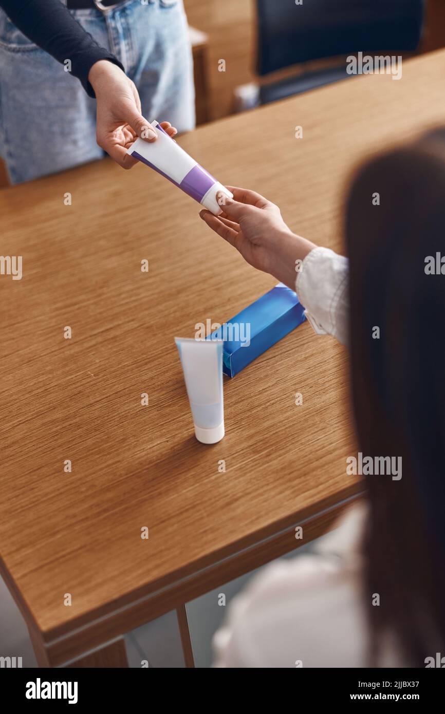 Toothpaste From Hospital Happy woman is taking a toothpaste from hands of clinic personal Stock ...