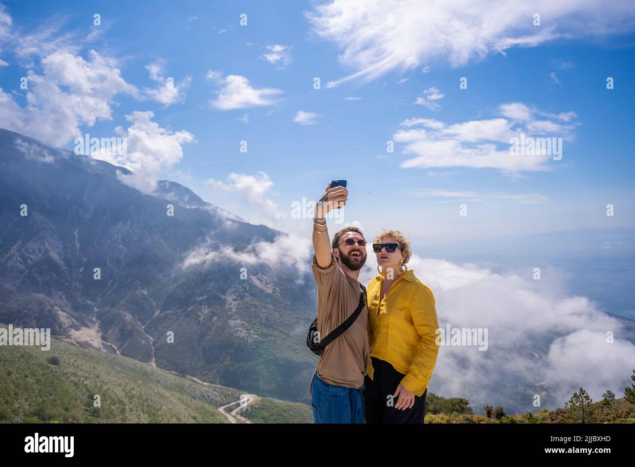 happy hiking couple taking selfie together on top of mountain Stock ...