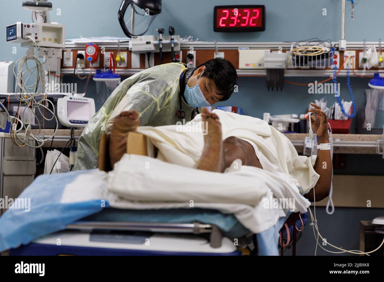 Trauma resident doctor Brian Park listens to an injured border wall fall patient after she arrived by ambulance for medial treatment at Scripps Mercy Hospital’s trauma unit in San Diego, California, U.S., May 25, 2022. REUTERS/Mike Blake Stock Photo