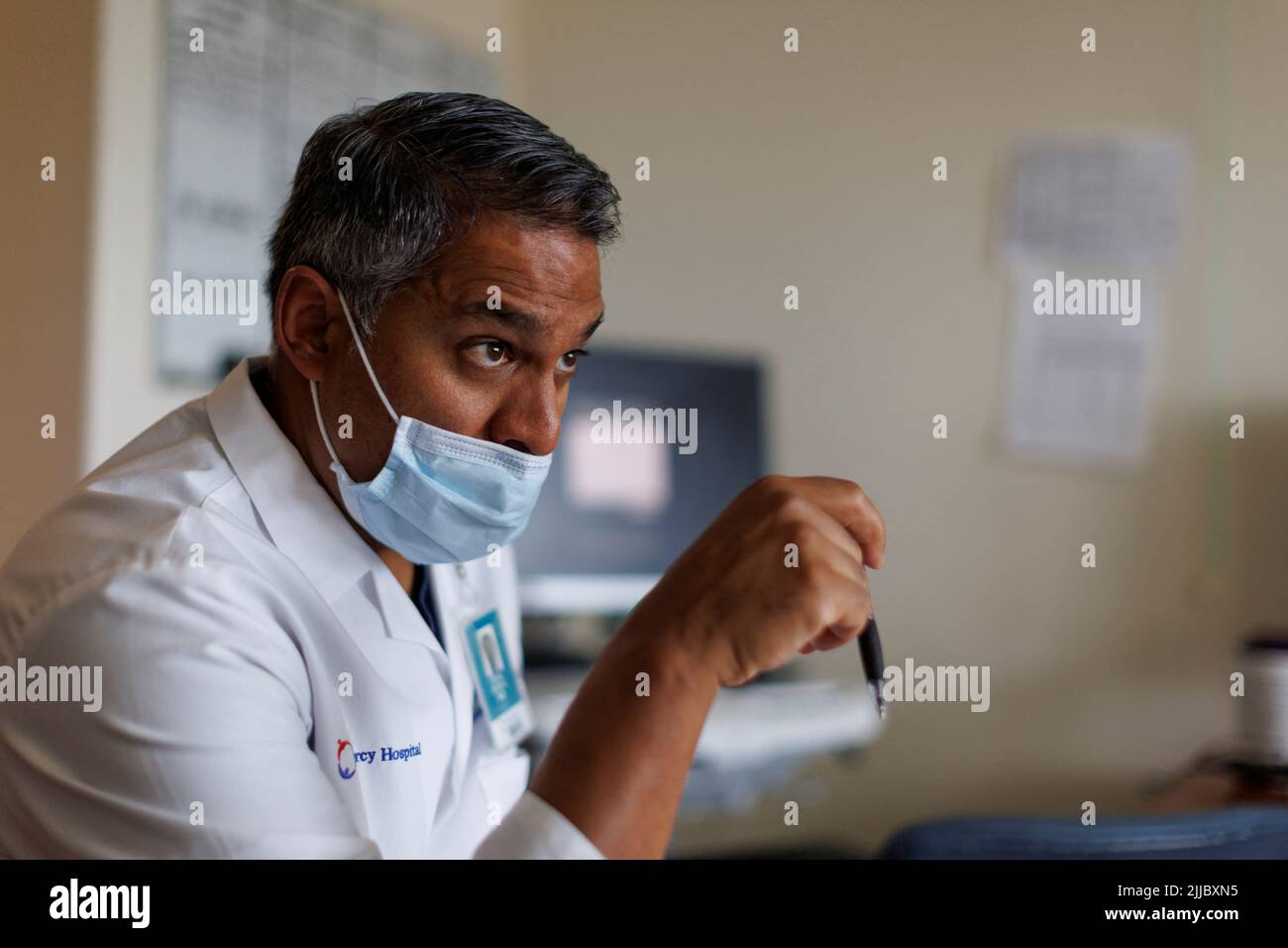 Dr. Vishal Bansal, head of the trauma unit at Scripps Mercy Hospital, meets with his resident MDs before visiting injured border wall fall patients during morning rounds in San Diego, California, U.S. May 20, 2022.  REUTERS/Mike Blake Stock Photo