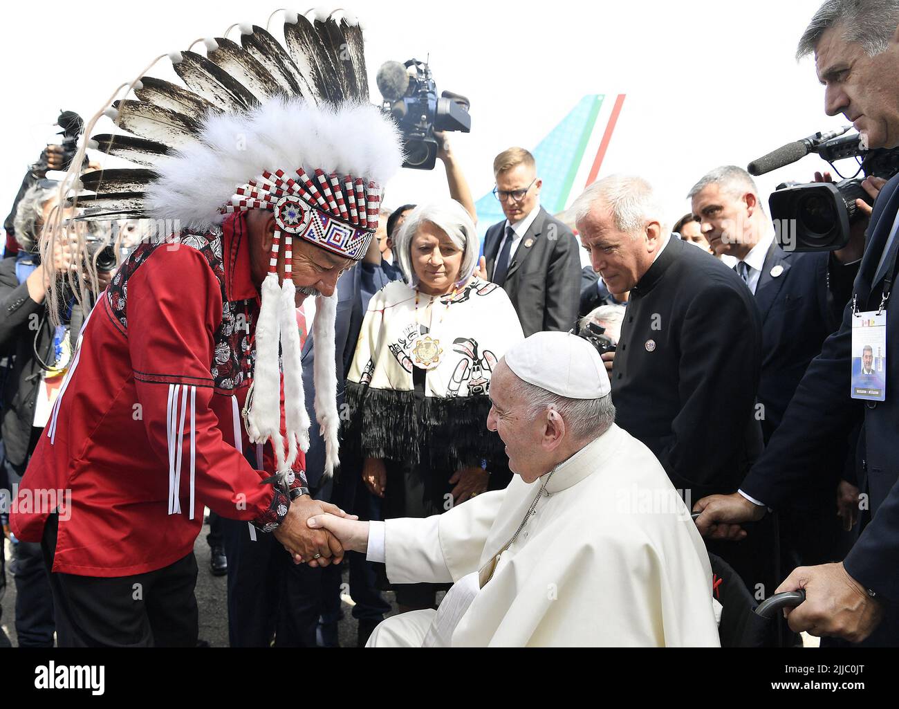Edmonton, Canada. 24th July, 2022. Pope Francis greets George Arcand (left), Grand Chief of the Confederacy of Treaty Six First Nations during his welcoming ceremony at Edmonton International Airport, AB, western Canada on July 24, 2022 for his six-day papal visit across Canada. Pope's visit to Canada is aimed at reconciliation with Indigenous people for the Catholic Church's role in residential schools. Photo by Vatican Media (EV)/ABACAPRESS.COM Credit: Abaca Press/Alamy Live News Stock Photo