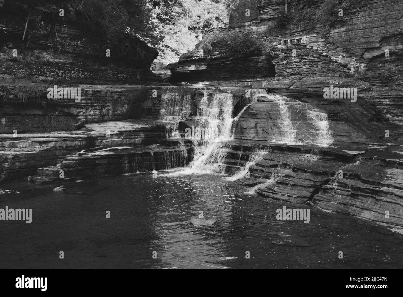 A grayscale shot of Lucifer Falls waterfall in New York State Stock Photo