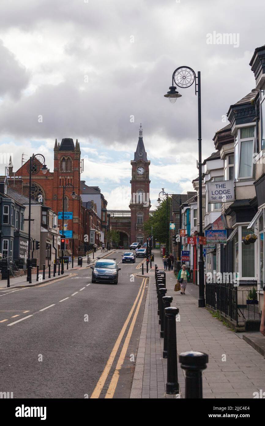 A street view of Victoria Road in Darlington,England,UK with the clock tower at the railway station in the background Stock Photo