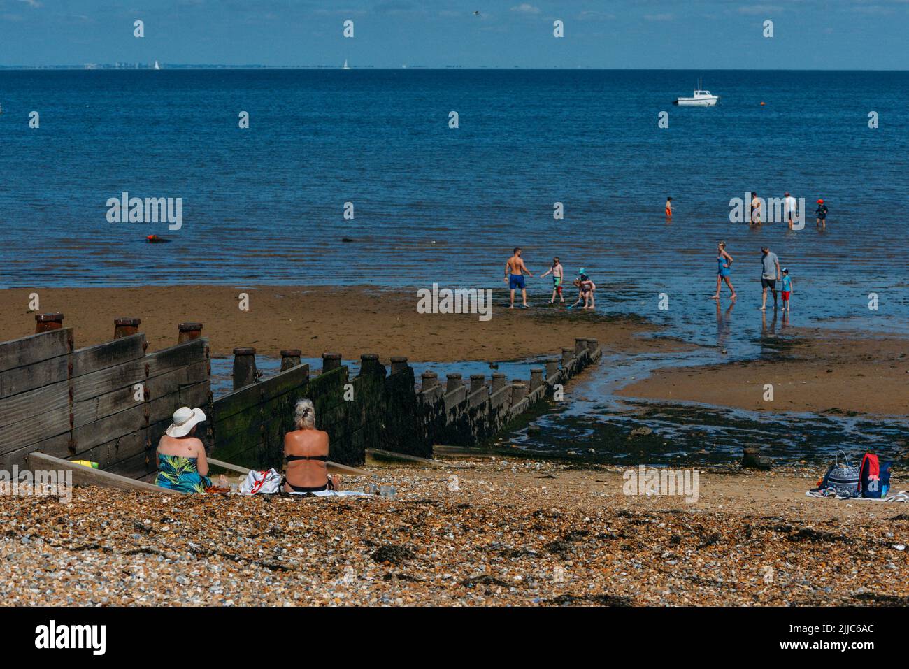 Whitstable, UK - July 16, 2022: People relax on the beach in Whitstable, Kent, UK on a hot summer day Stock Photo