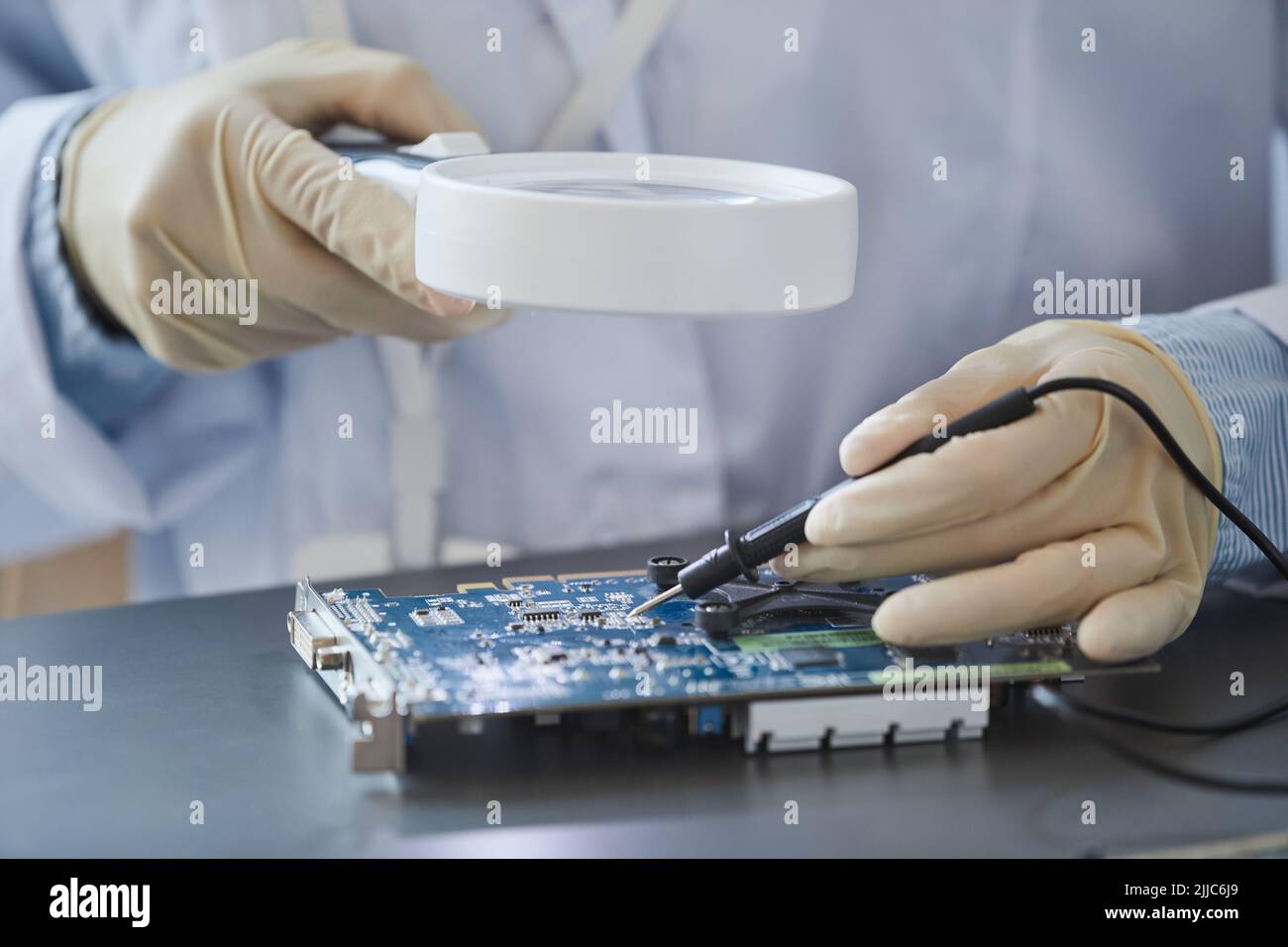 Closeup of unrecognizable female engineer inspecting hardware with magnifying glass, copy space Stock Photo