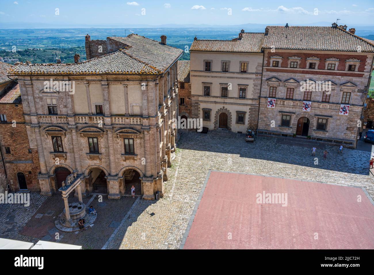 Elevated view of medieval palaces and well on Piazza Grande from the tower of Palazzo Comunale in the hilltop town of Montepulciano in Tuscany, Italy Stock Photo