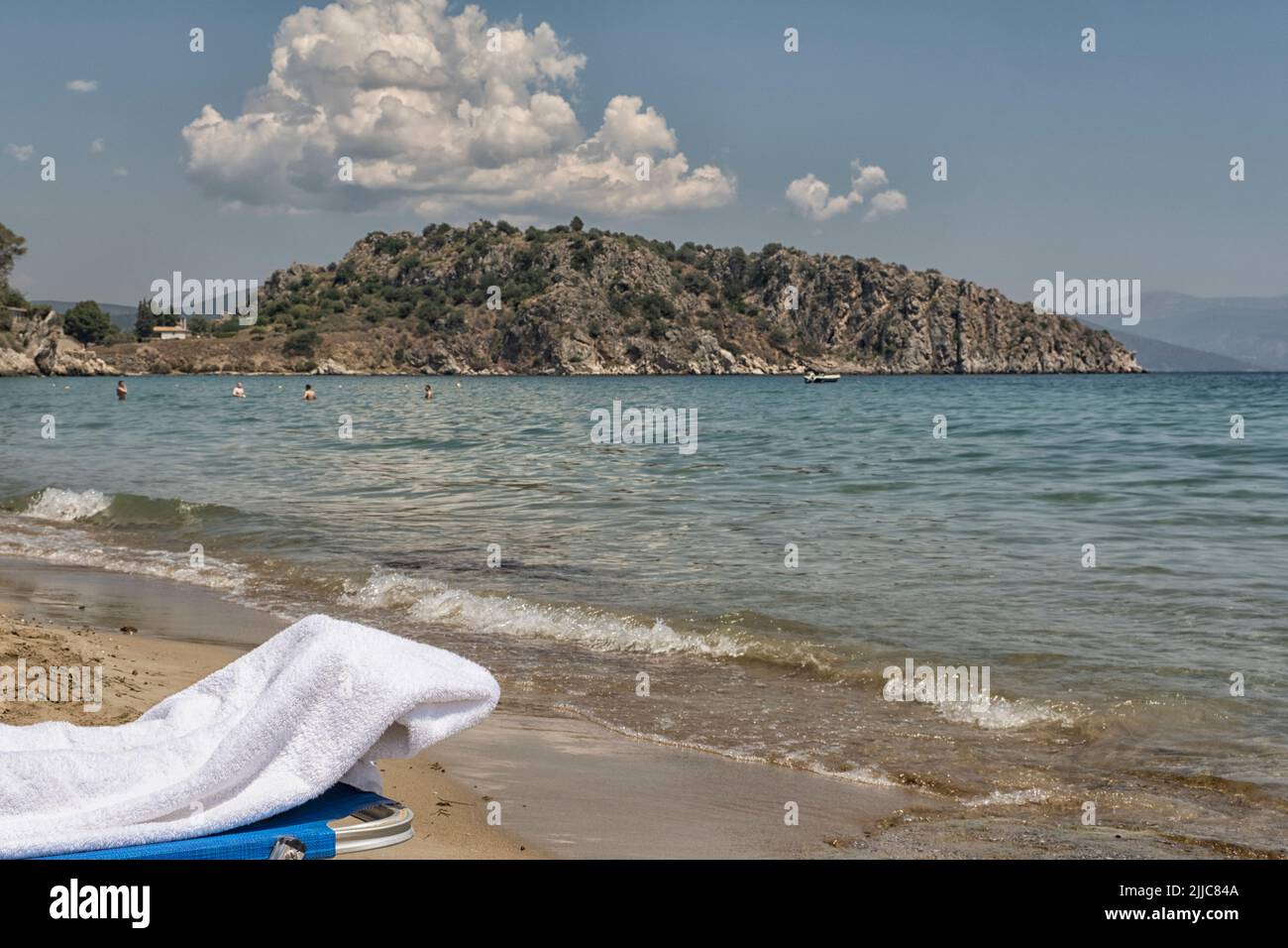Greek beach with sunbeds and Mediterranean Sea Stock Photo