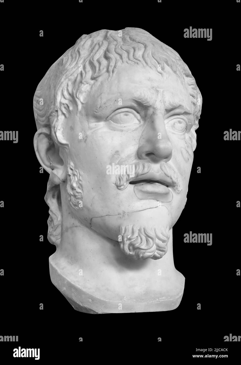 Head of the ancient man with beard sculpture. Antique barbarian face with whiskers statue isolated on black with clipping path Stock Photo