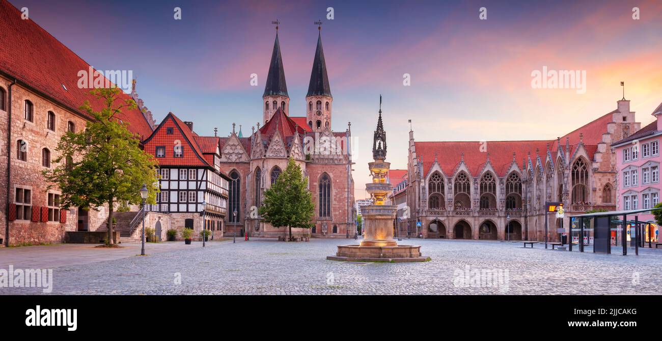Brunswick, Germany. Panoramic cityscape image of historical downtown of Brunswick, Germany with St. Martini Church and Old Town Hall at summer sunset Stock Photo