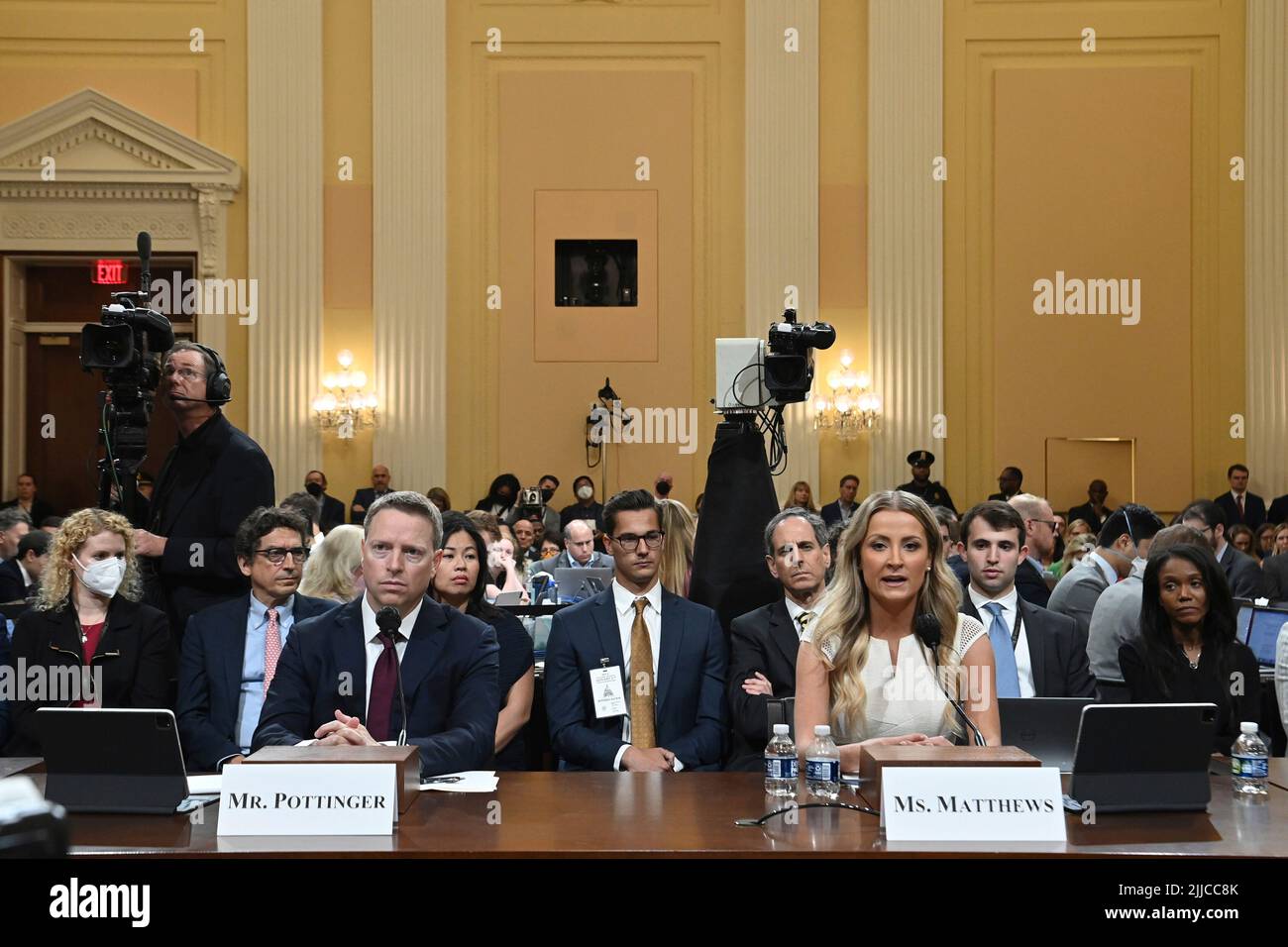 Former National Security Council member Matthew Pottinger (L) listens
