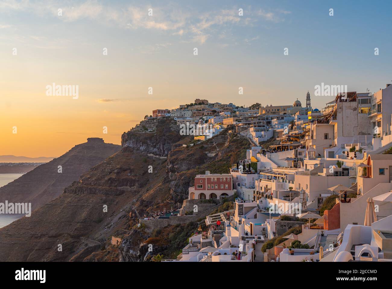 FIRA, GREECE - MAY 21.2022: View at sunset time from Fira, the capital of Santorini island in Greece Stock Photo