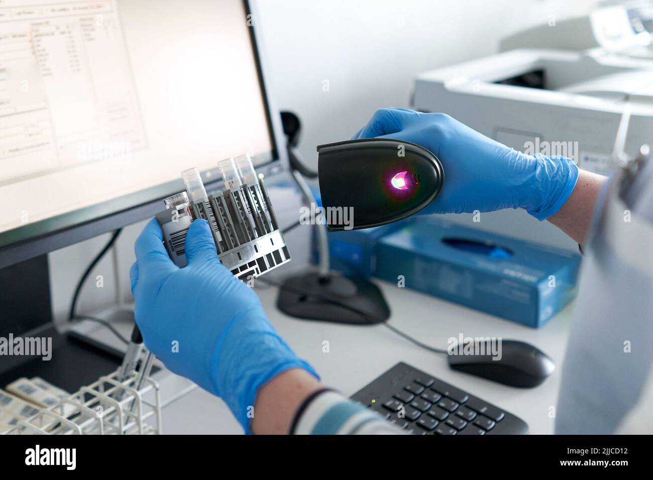 Person scanning vessel reaction in a laboratory of an hospital Stock