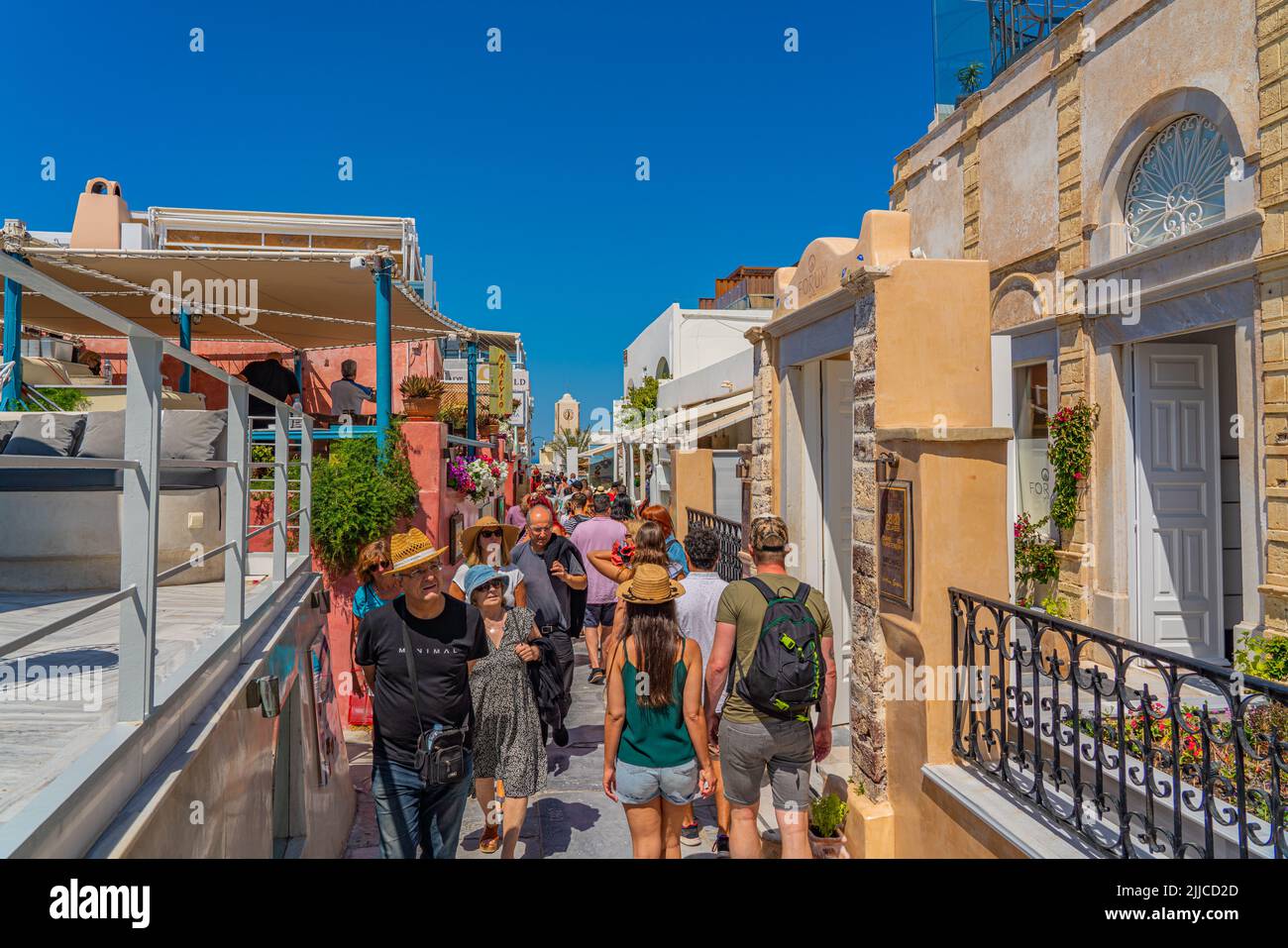 OIA, GREECE - MAY 22.2022: Souvenir shops of Oia with traditional white houses, Santorini island, Greece Stock Photo