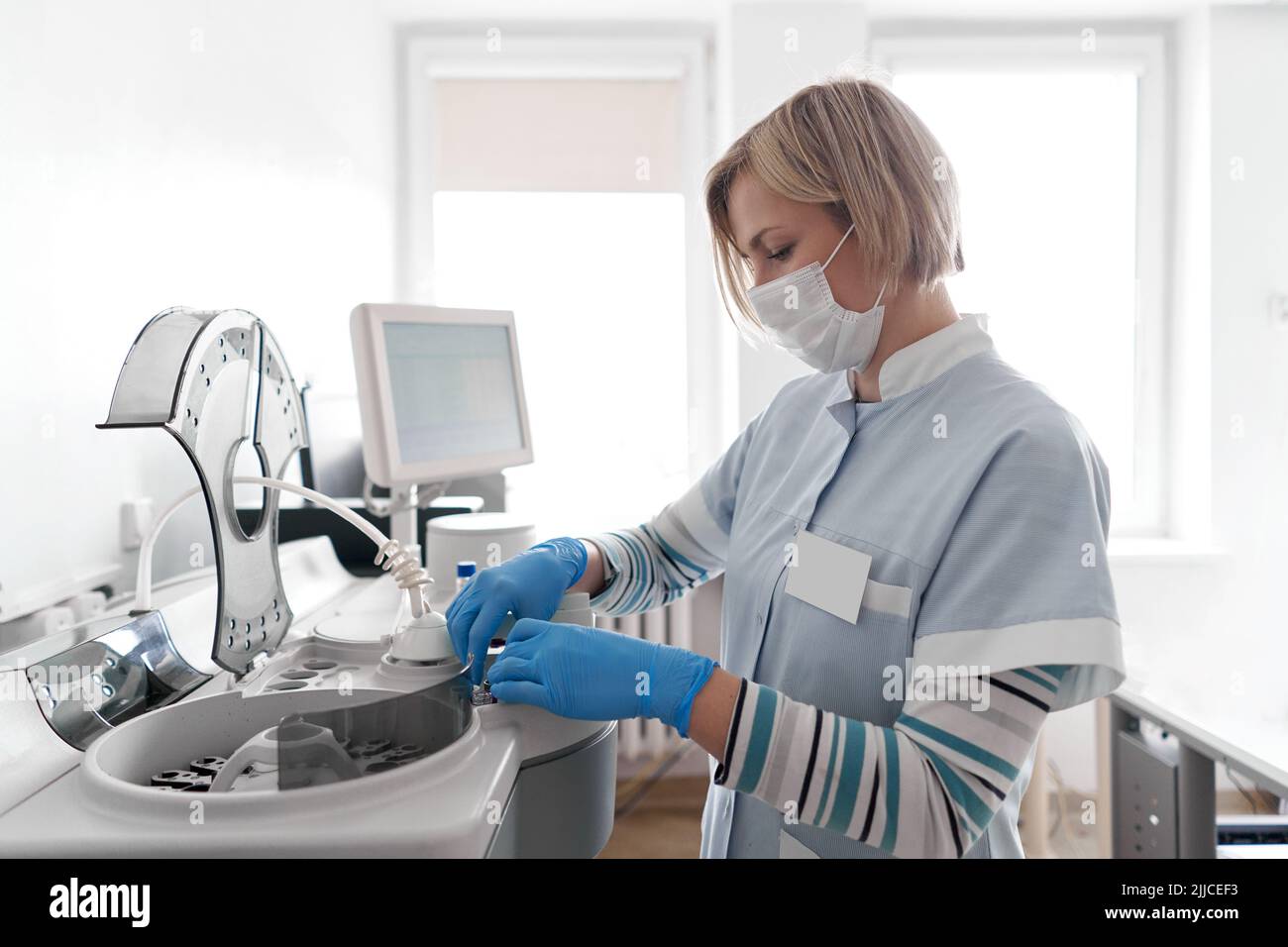 Nurse using a centrifuge in a hospital Stock Photo Alamy