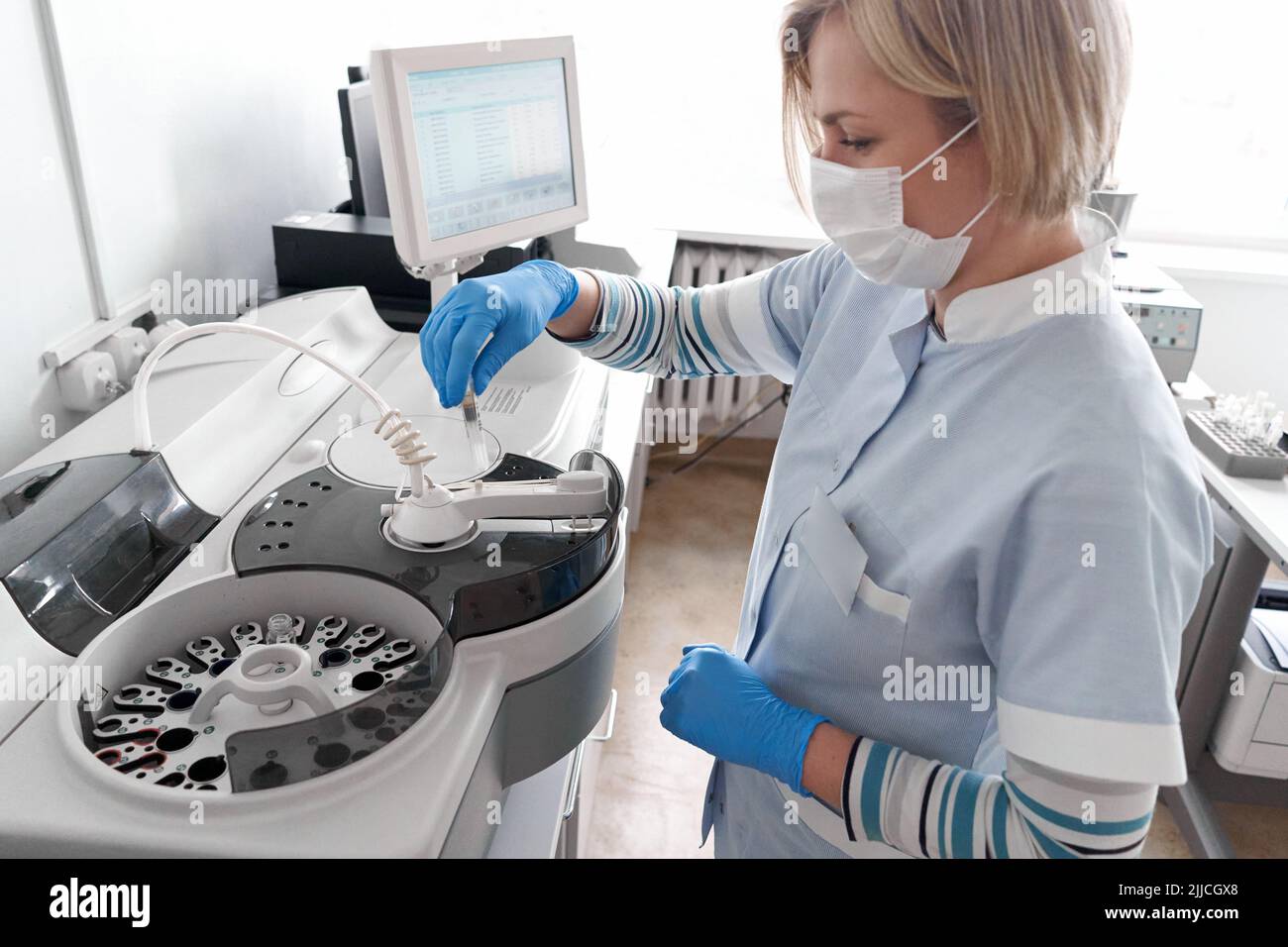 Doctor using a centrifuge in a hospital Stock Photo Alamy