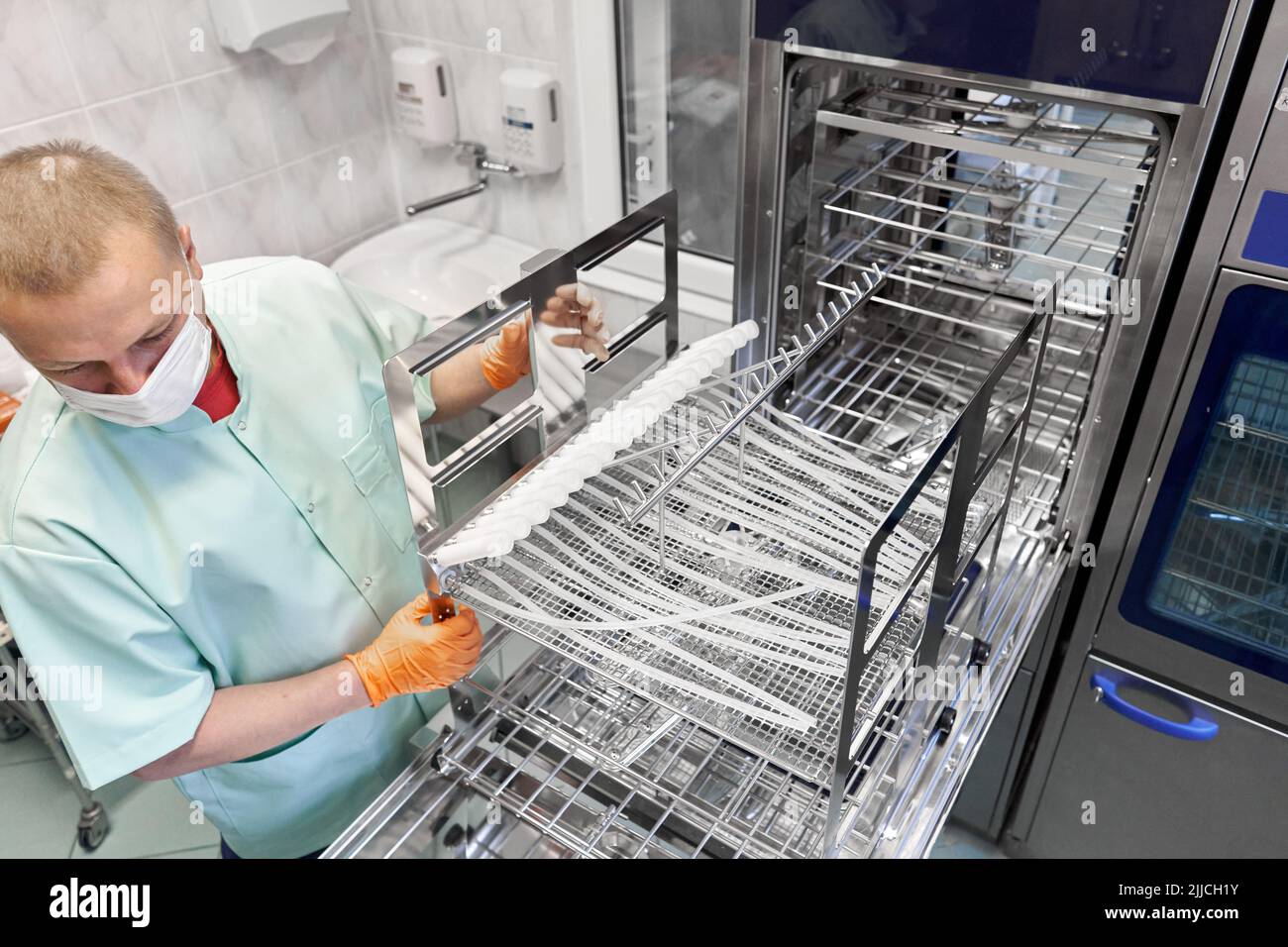 Nurse using a machine to sterilising medical supplies in an hospital Stock Photo