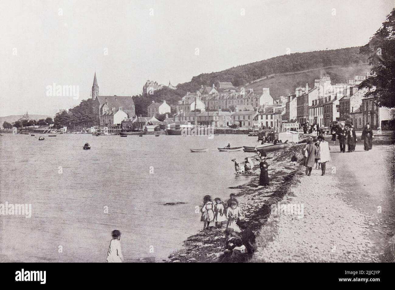 Port Bannatyne, Isle of Bute, Firth of Clyde, Scotland, seen here in the 19th century.   From Around The Coast,  An Album of Pictures from Photographs of the Chief Seaside Places of Interest in Great Britain and Ireland published London, 1895, by George Newnes Limited. Stock Photo