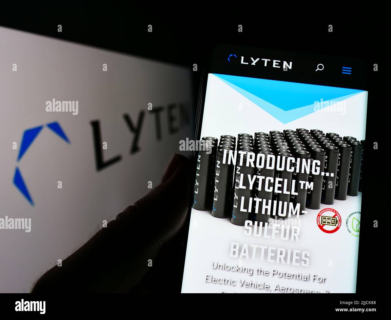 Person holding cellphone with website of US battery company Lyten Inc. on screen in front of business logo. Focus on center of phone display. Stock Photo