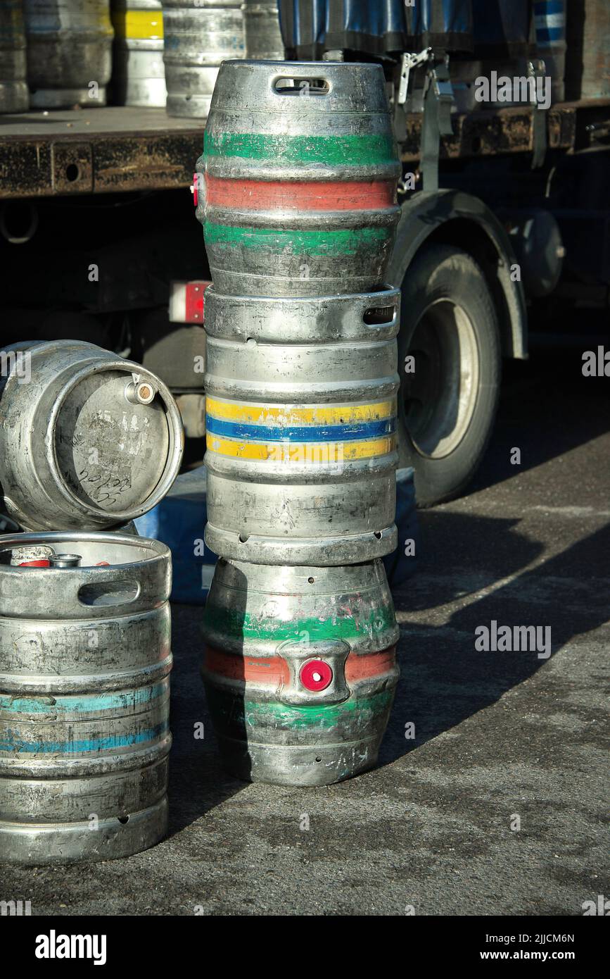 Metal beer kegs being delivered by lorry to a public house Stock Photo