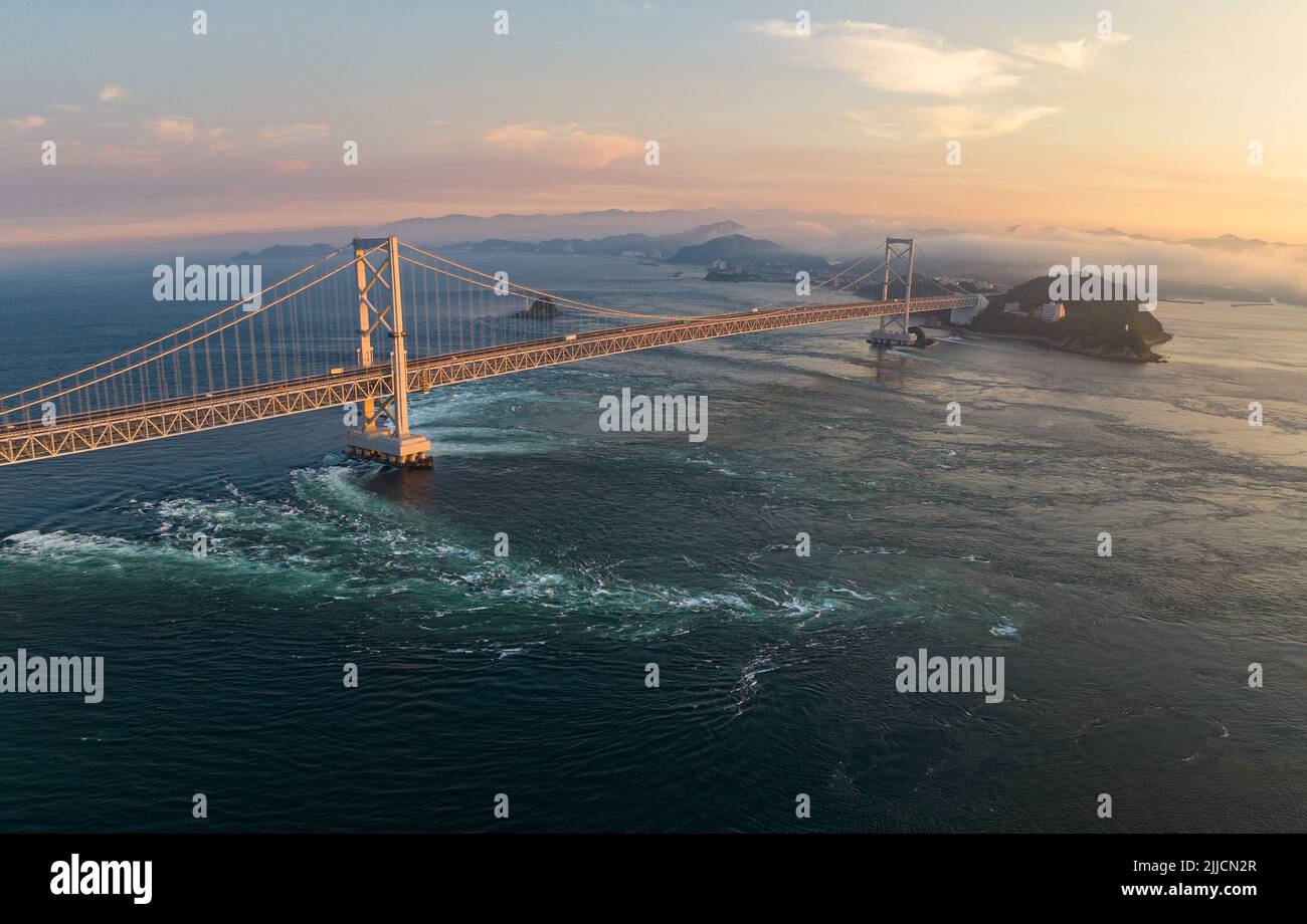 Aerial view of strong current under Naruto bridge at sunset Stock Photo