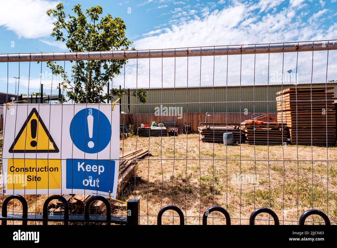 Dorking Surrey Hills London UK, July 24 2022, Builders Material Storage Yard With Warning Signs And Security Fence Stock Photo