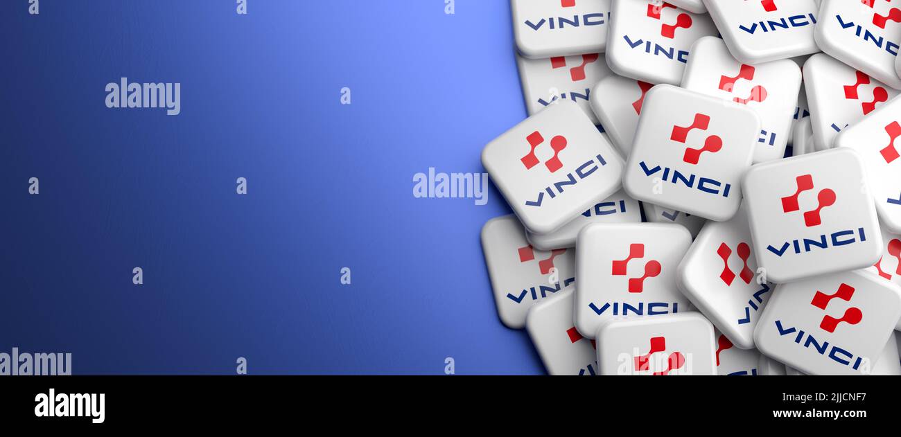 Logos of the French concessions and construction company VINCI on a heap on a table. Copy space. Web banner format. Stock Photo
