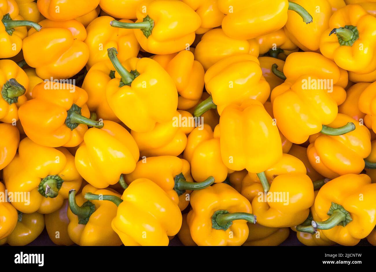 Yellow peppers for sale in the market at Kalamata, in the Peloponnese, Southern Greece. Stock Photo