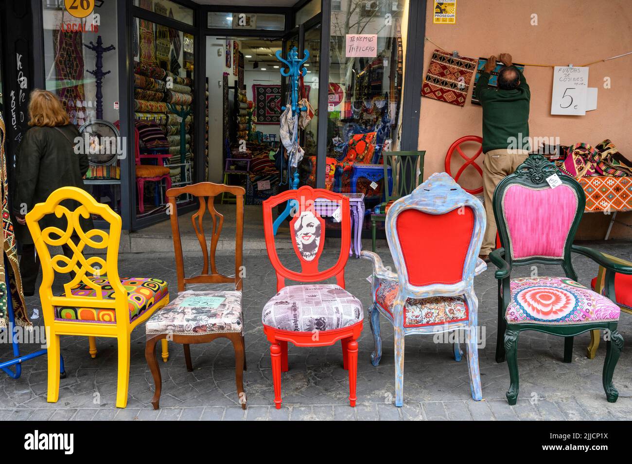 A selection of restored chairs on sale in the Rastro flea market around the Plaza de Cascorro between La Latina and Embajadores,  Madrid, Spain. Stock Photo