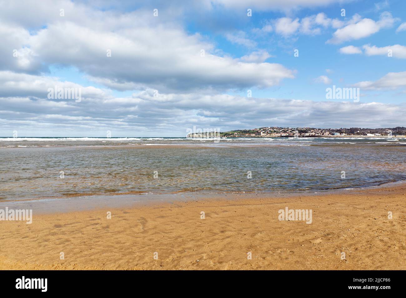 Beach overlooking the shore of a coastal city on a cloudy day. Concept travel, vacation Stock Photo