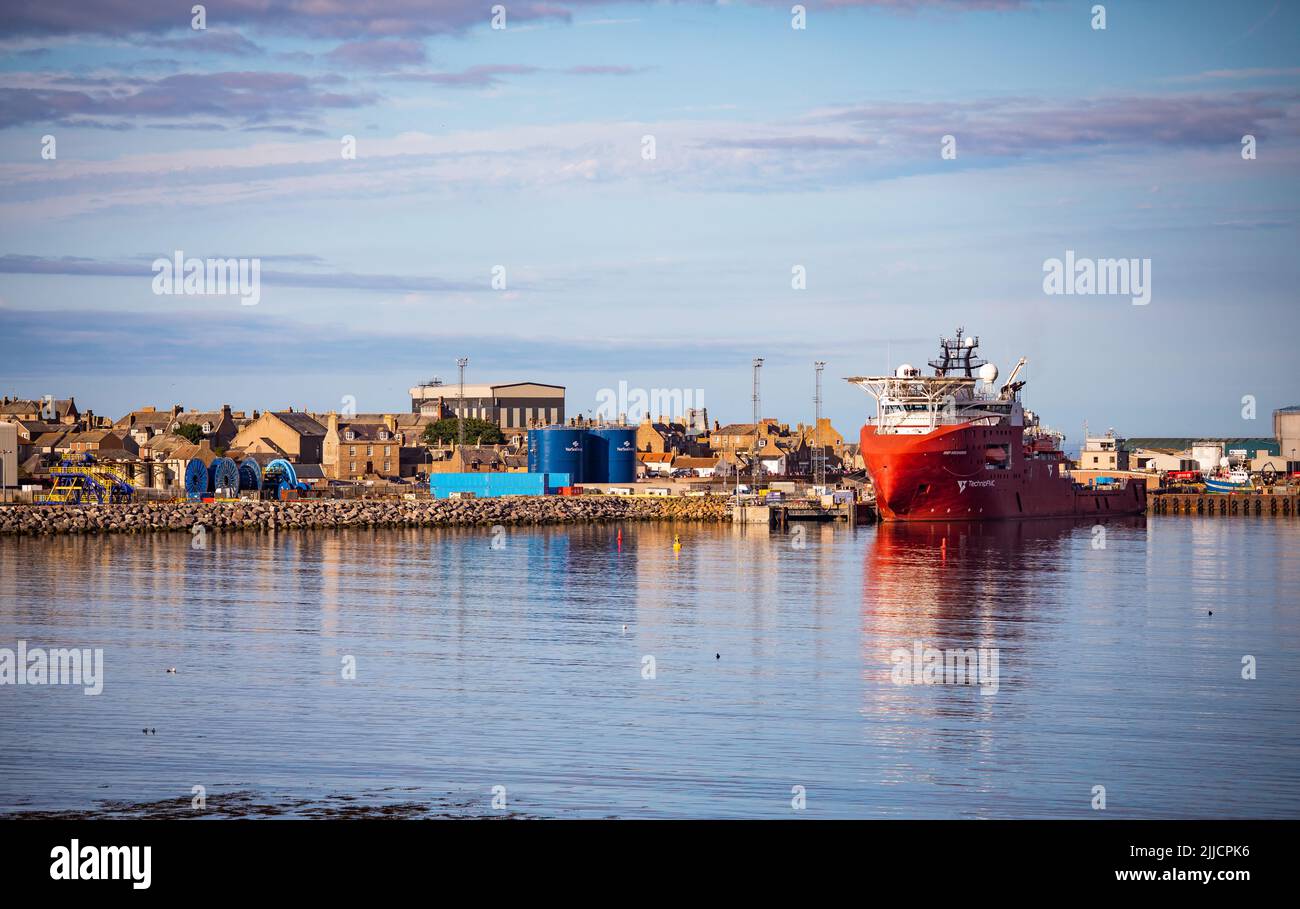 An oil supply boat at the harbour at the fishing and energy town of Peterhead, Aberdeenshire, Scotland Stock Photo