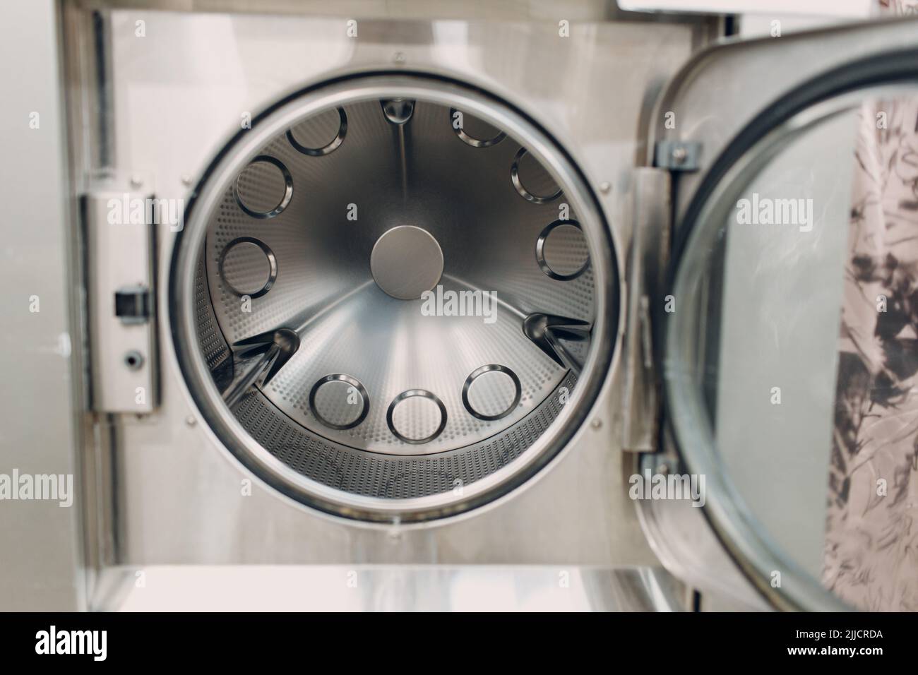 Dry cleaning dry dryer clothes. Clean cloth chemical process. Open door