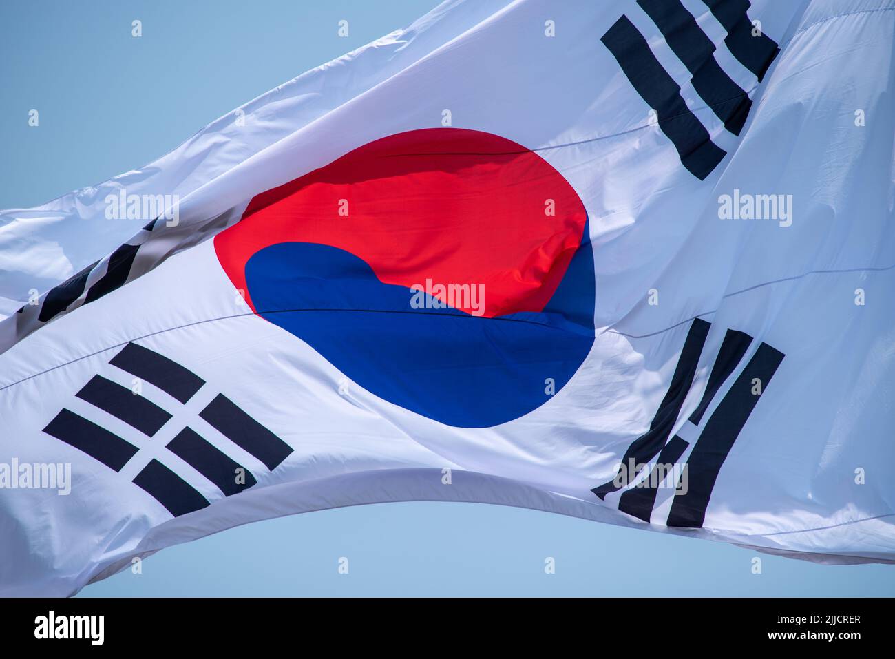 Closeup Flag of South Korea on a flagpole against the blue sky Stock Photo