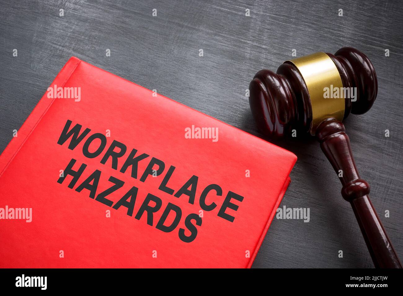 Book about safety workplace hazards and gavel. Stock Photo