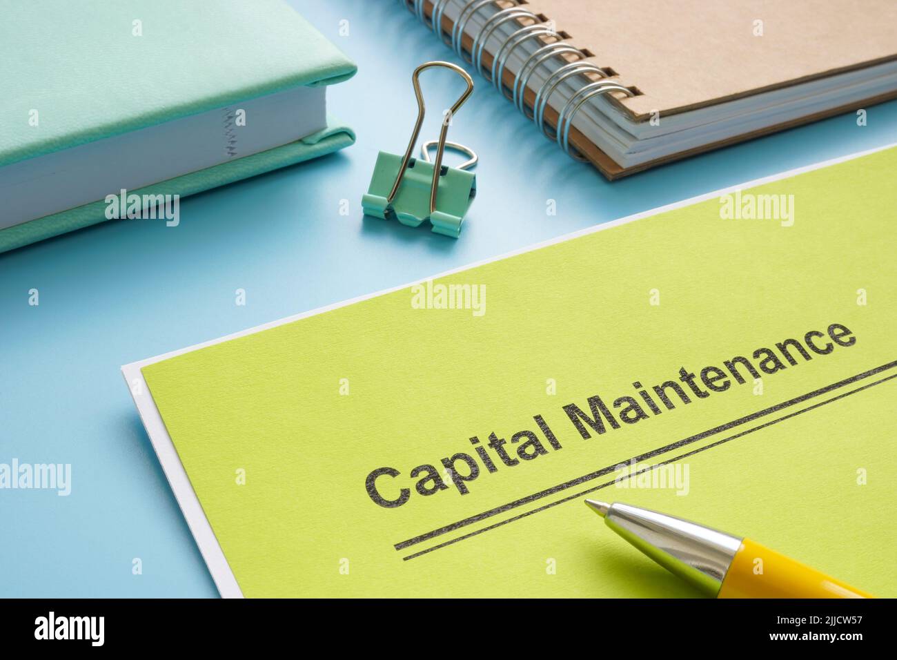 Papers about capital maintenance near the notepad. Stock Photo