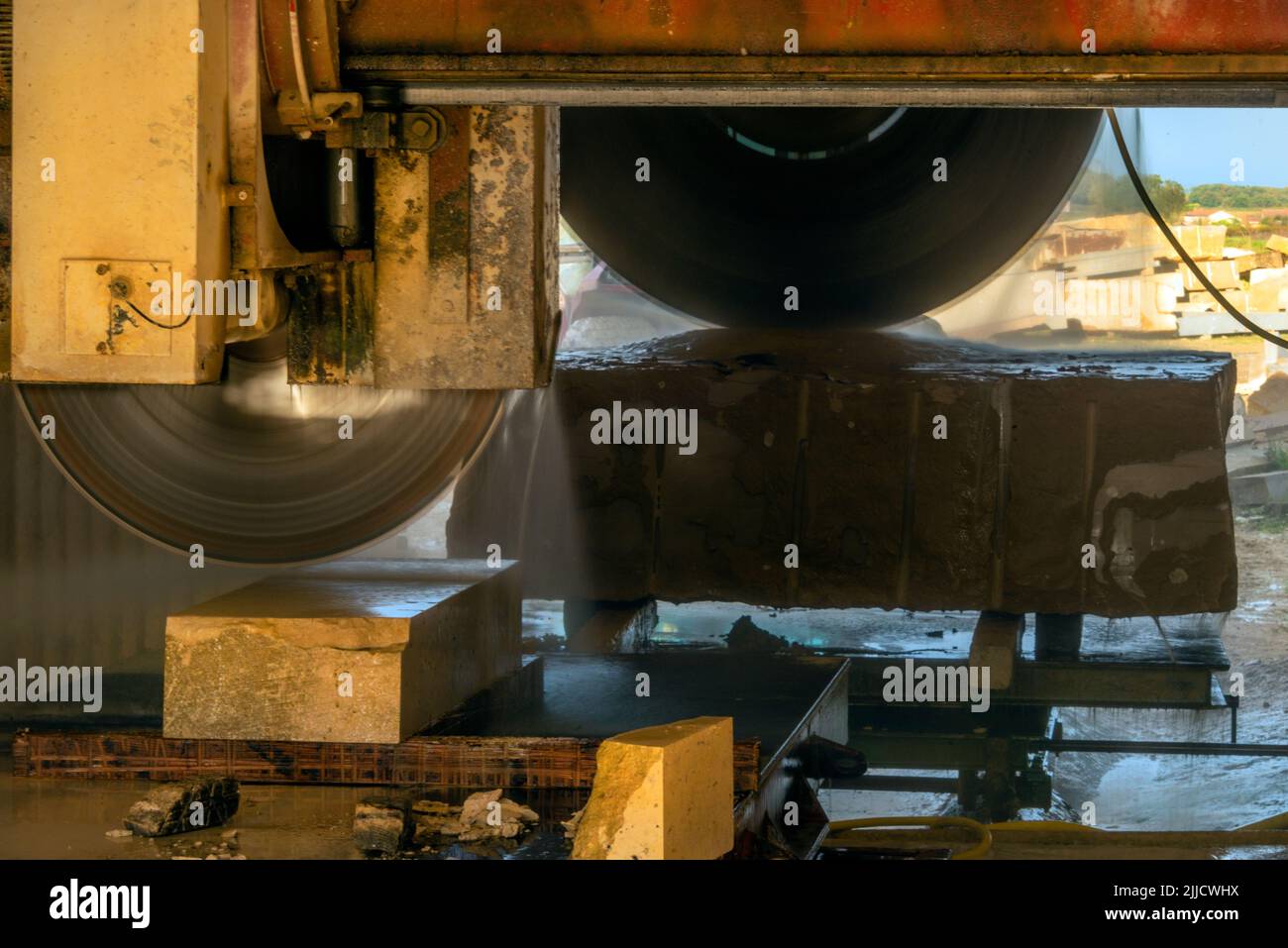 A circular saw cutting a block of limestone at a stone masons yard