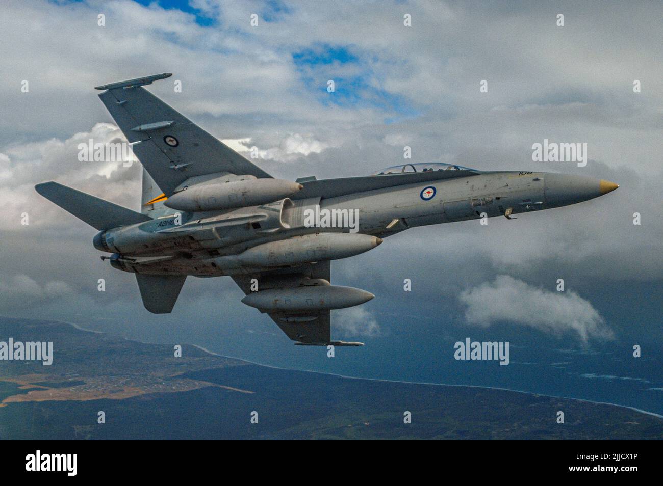 An air to air shot of an RAAF, two seat, McDonnell Douglas (now Boeing) F/A18 Hornet jet fighter banking. Stock Photo