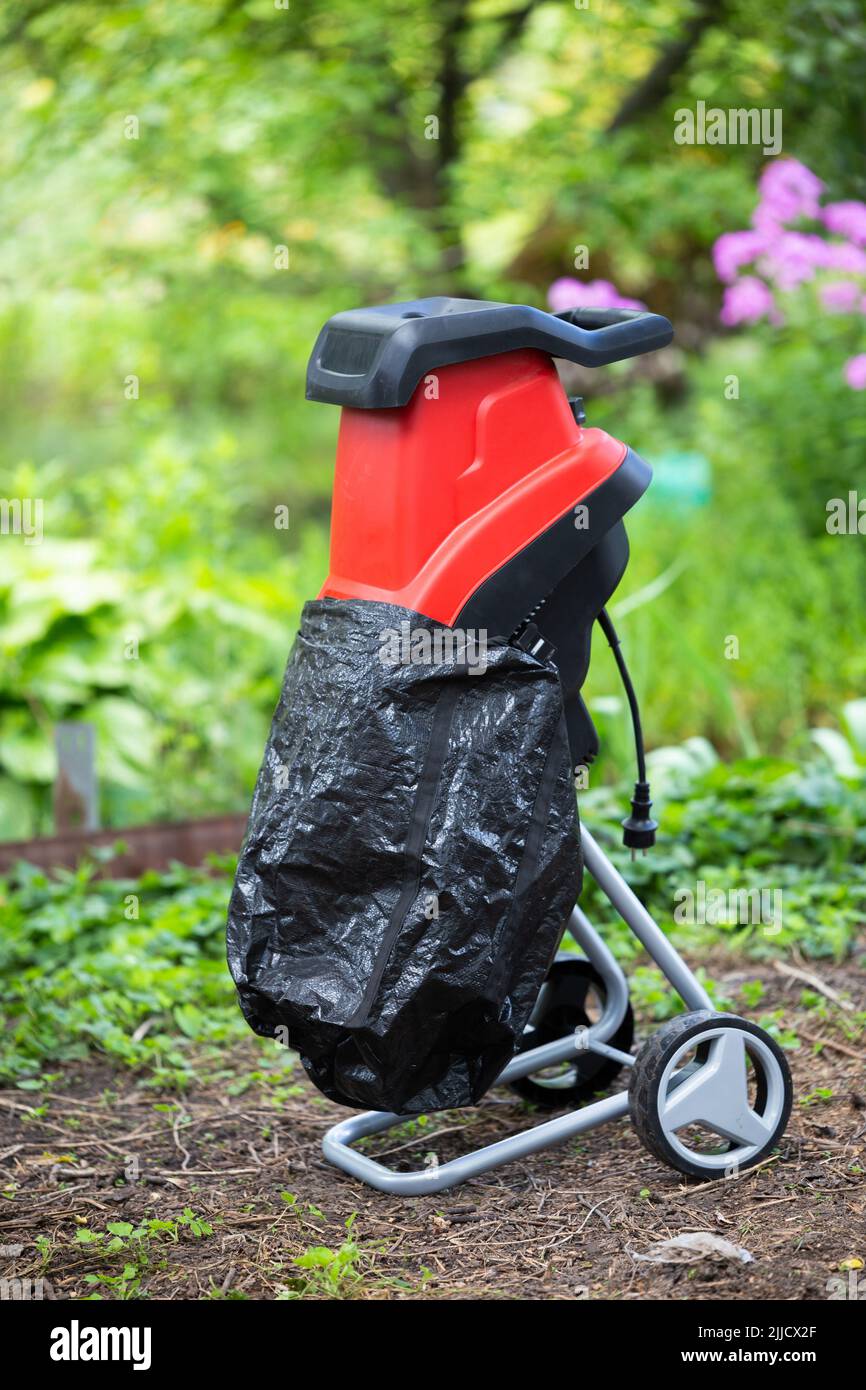 Garden chipper, electric shredder mulcher against the background of the