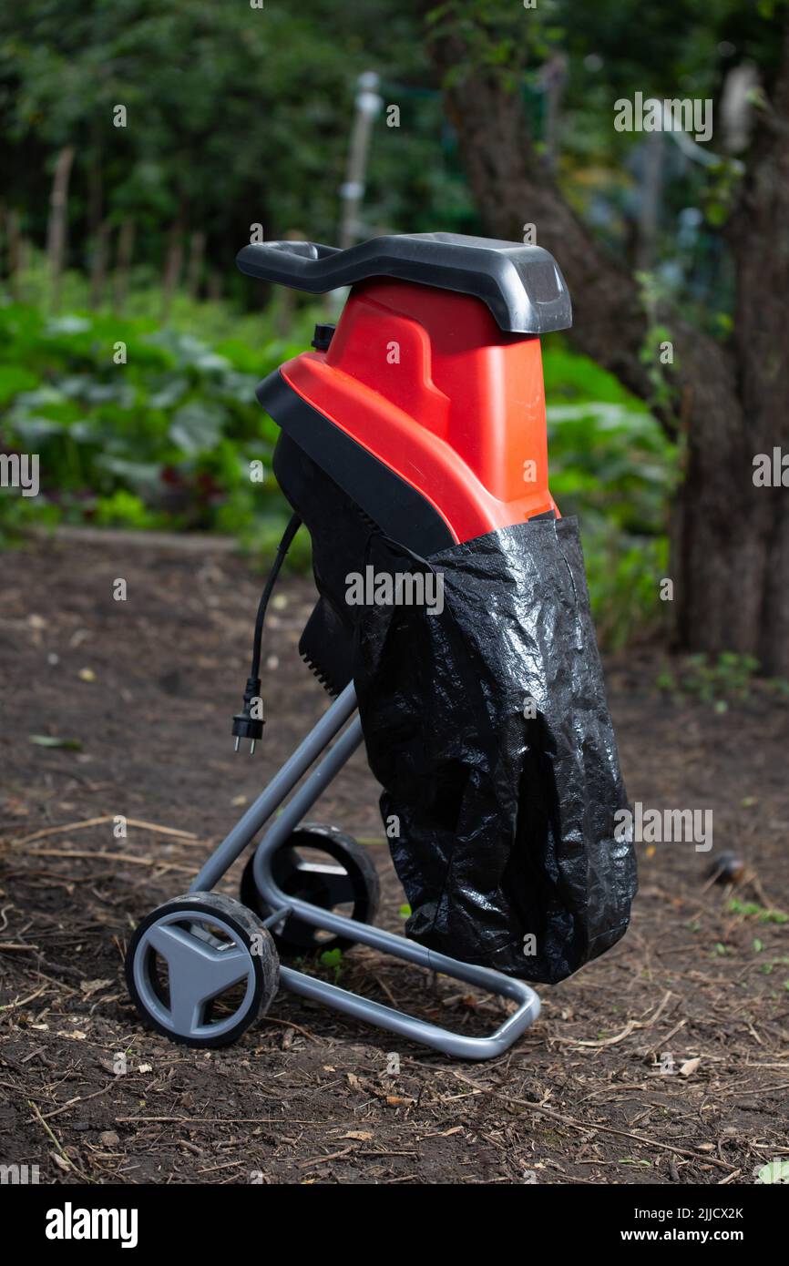 Garden chipper, electric shredder mulcher against the background of the